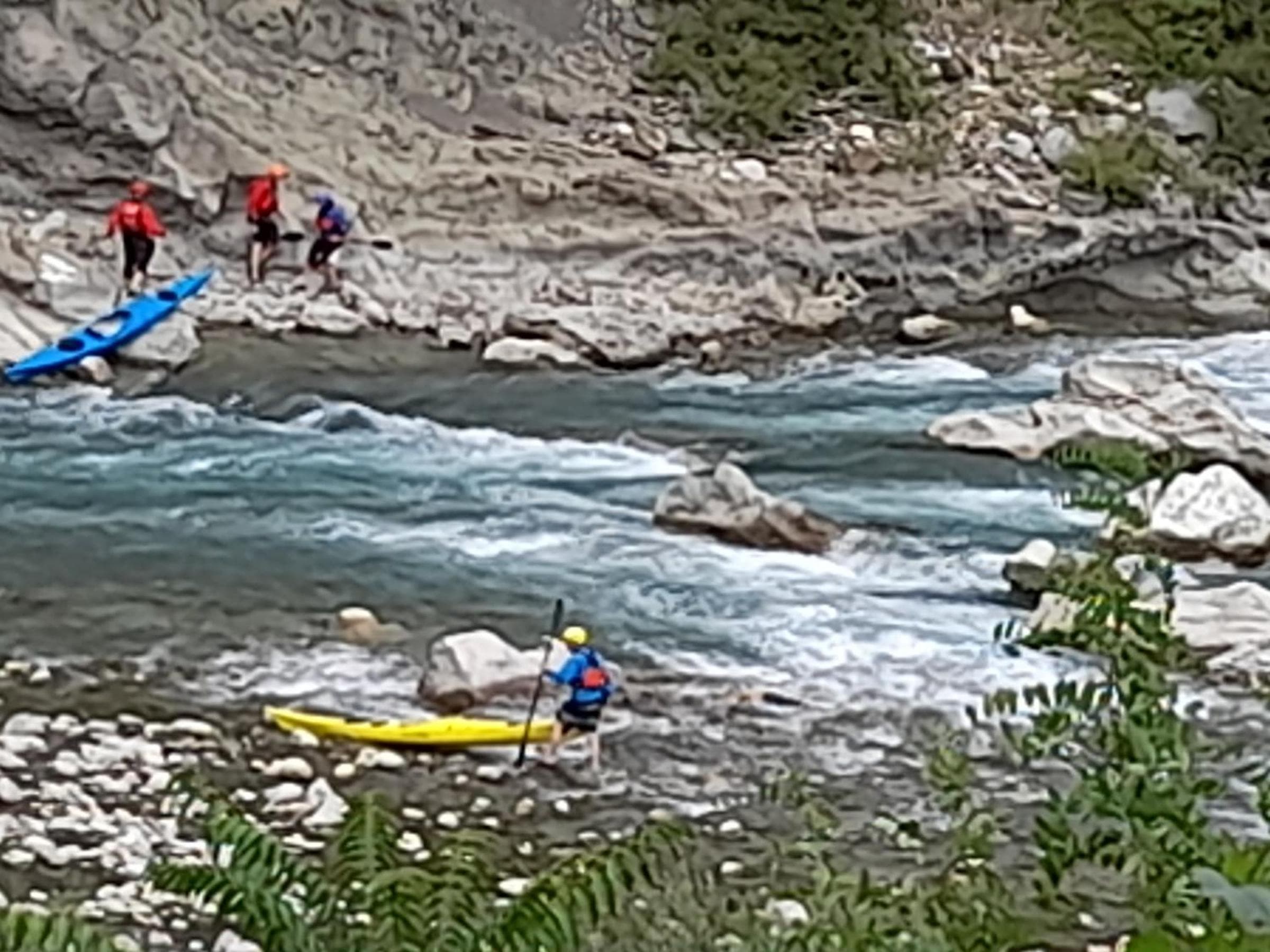 Kayaks strung out along a shallow reach of the Vjosa