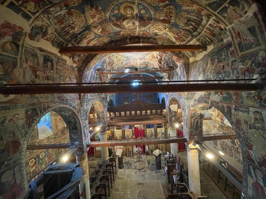 The frescoed interior of a village church above Përmet