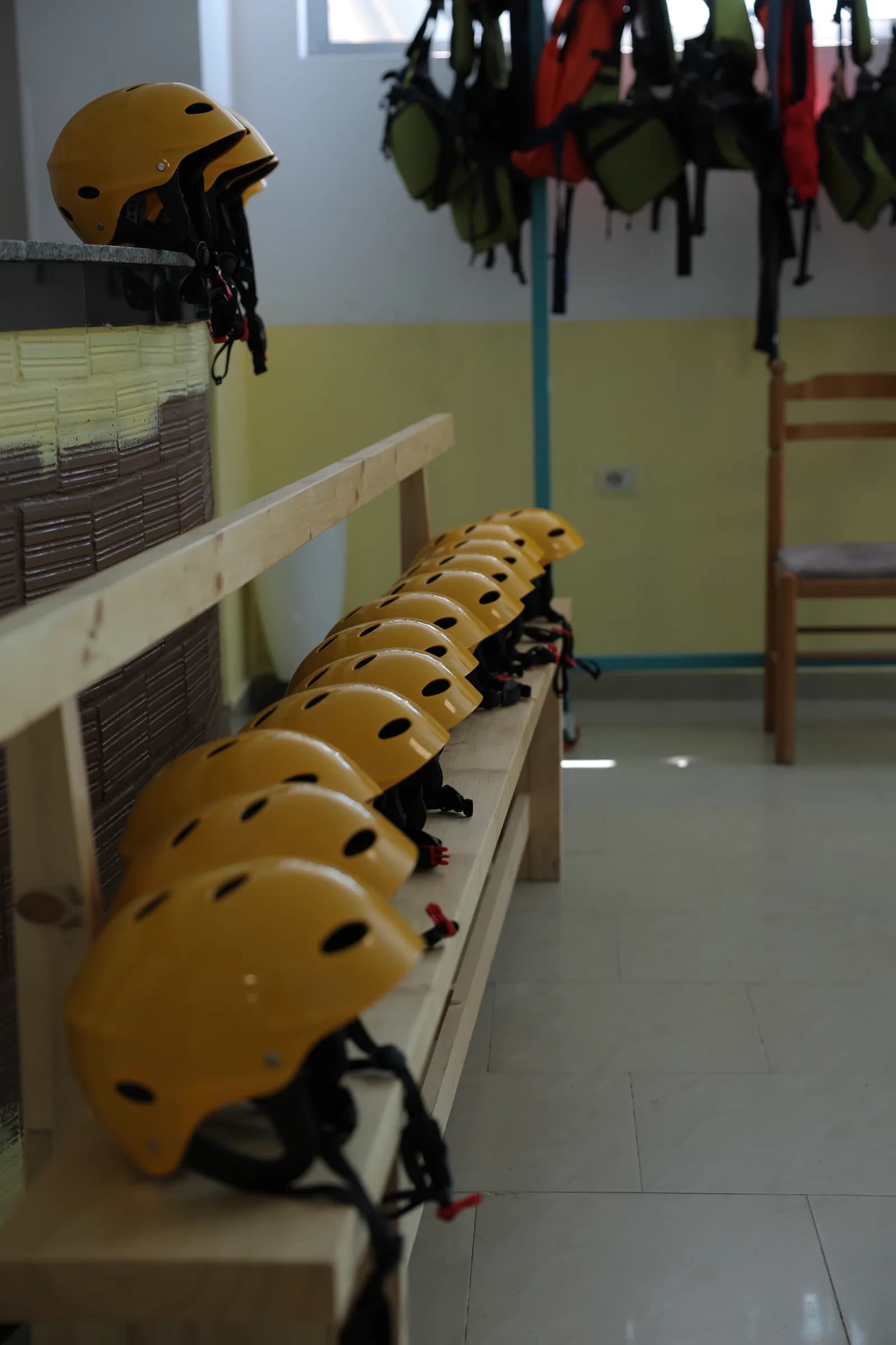 Helmets lined up in the gear room at base camp